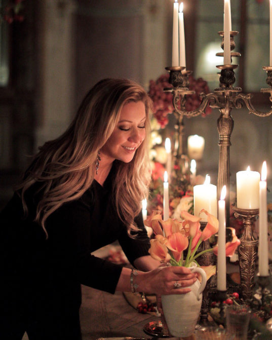 Wedding planner, Michelle Durpetti, arranging floral design.
