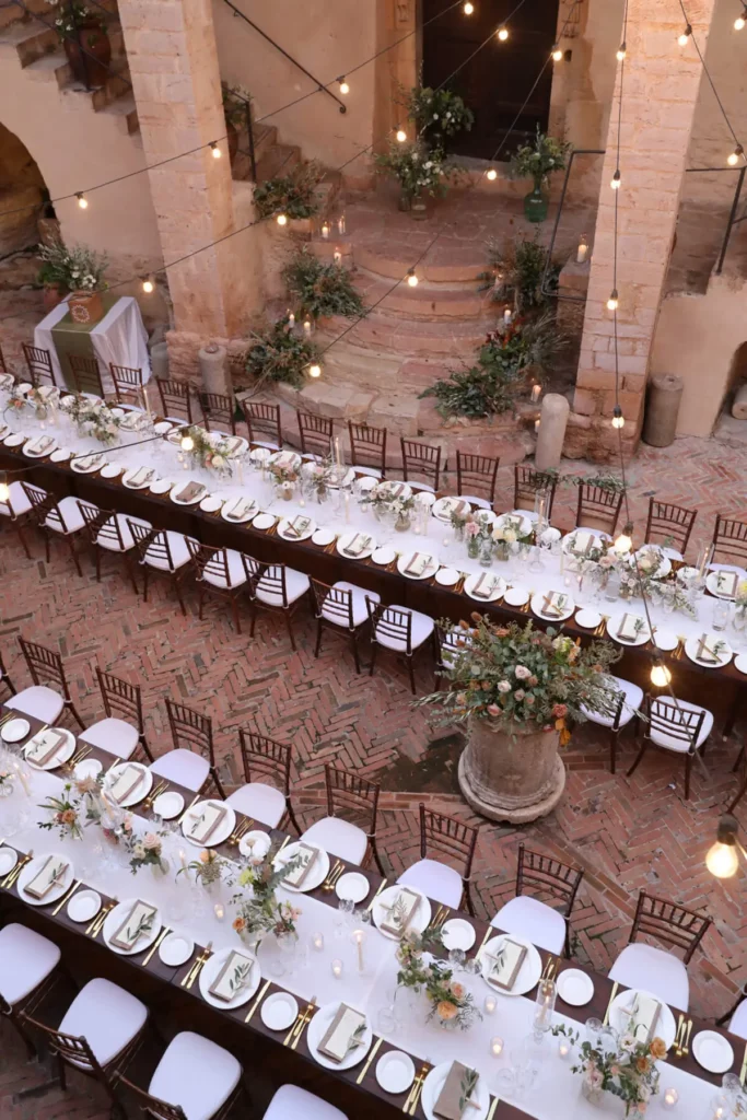 Italian destination wedding in Umbria, Italy, two long tables in courtyard for wedding reception.