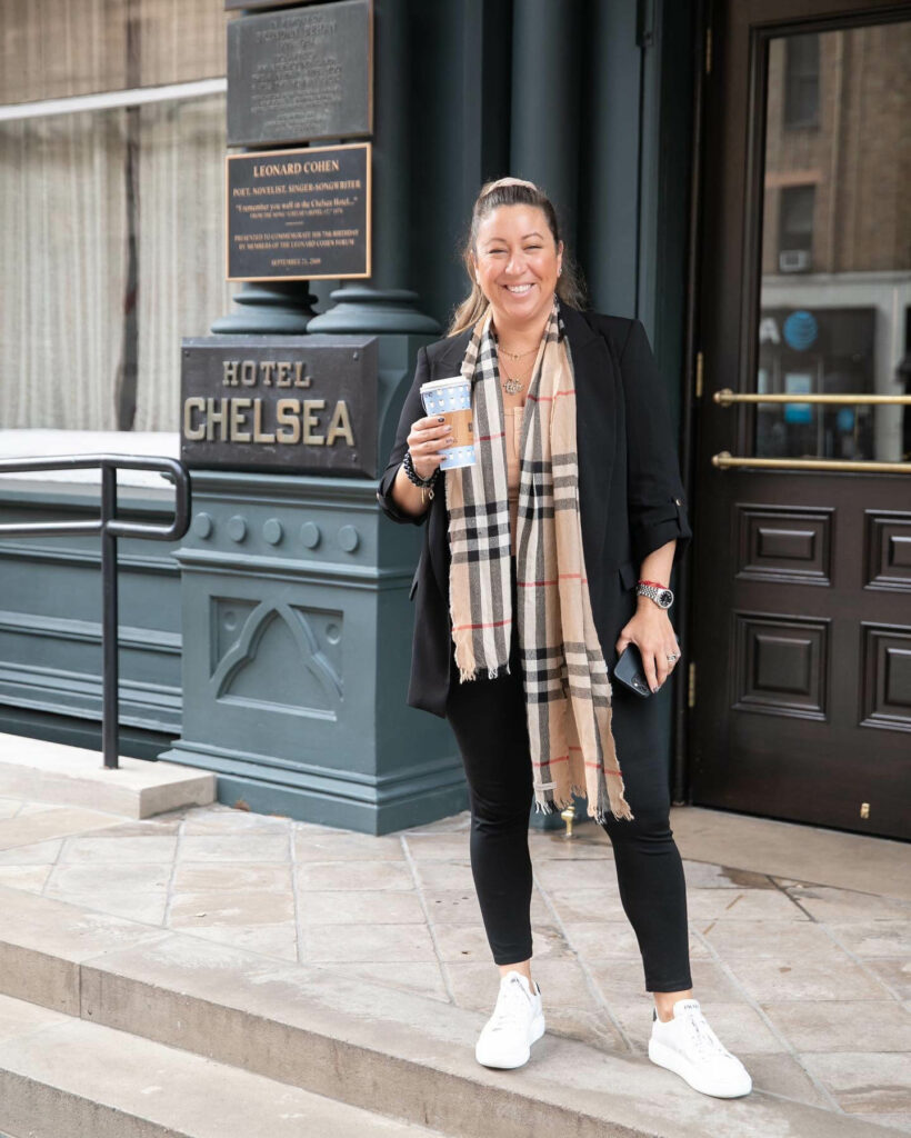 Michelle Durpetti facing camera standing with coffee, wearing scarf during 2022 New York Bridal Fashion Week